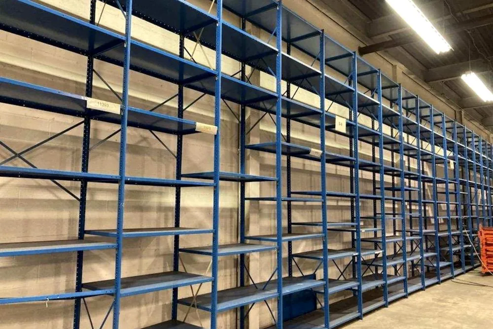 Blue industrial shelving run in a warehouse