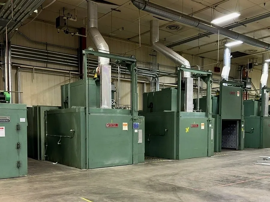 Row of industrial ovens being decommissioned in a plant